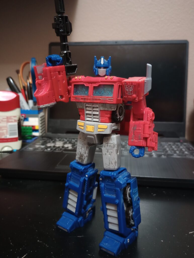 Siege Optimus Prime standing, brandishing his Ion Blaster.